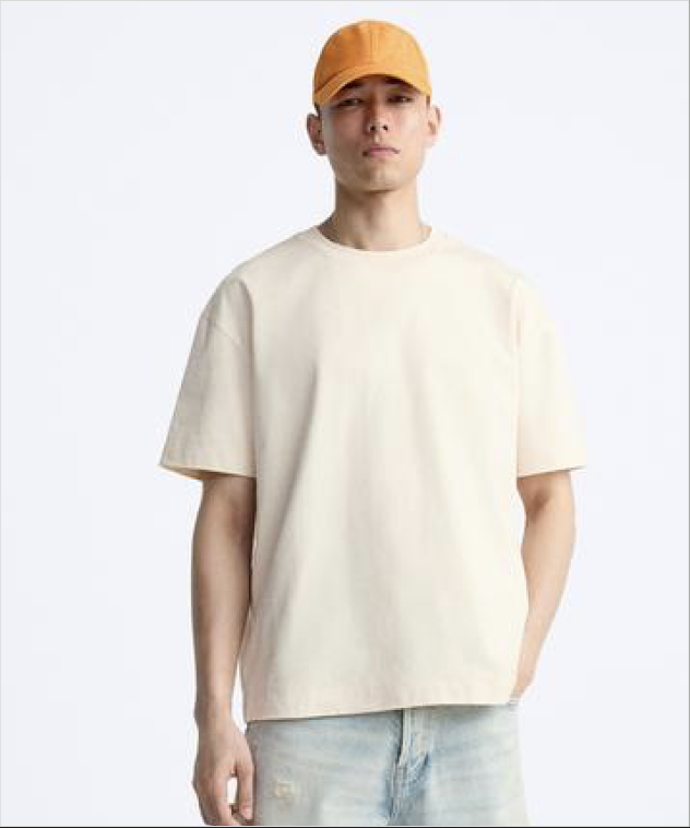 Model wearing a light blue t-shirt on a white studio background